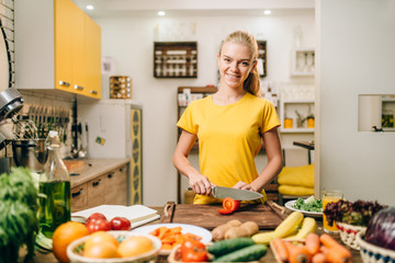 Young woman cooking on recipes, healthy bio food