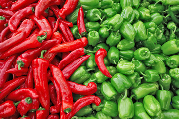 Wall Mural - Fresh green and red organic bell peppers capsicum on display for sale at local farmer's market departmental store.