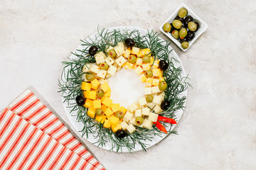 christmas wreath cheese with olives on marble background, top view