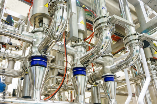Fotografía Industrial factory equipment stainless tubes food automation.