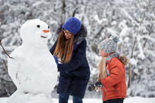 Winter Fun. A Girl And A Boy Making Snowballs.