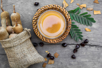 Wall Mural - Tamarind and tamarind juice with honey on wooden background