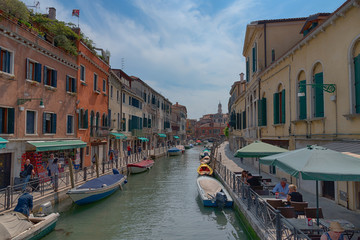 Wall Mural - Traditional narrow canal street with gondolas and old houses in Venice, Italy. Architecture and landmarks of Venice. Beautiful Venice postcard.