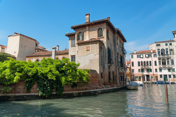 Wall Mural - Traditional narrow canal street with gondolas and old houses in Venice, Italy. Architecture and landmarks of Venice. Beautiful Venice postcard.