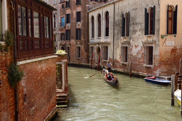 Wall Mural - Traditional narrow canal street with gondolas and old houses in Venice, Italy. Architecture and landmarks of Venice. Beautiful Venice postcard.