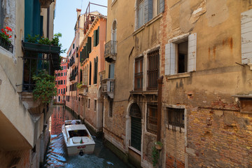 Wall Mural - Traditional narrow canal street with gondolas and old houses in Venice, Italy. Architecture and landmarks of Venice. Beautiful Venice postcard.