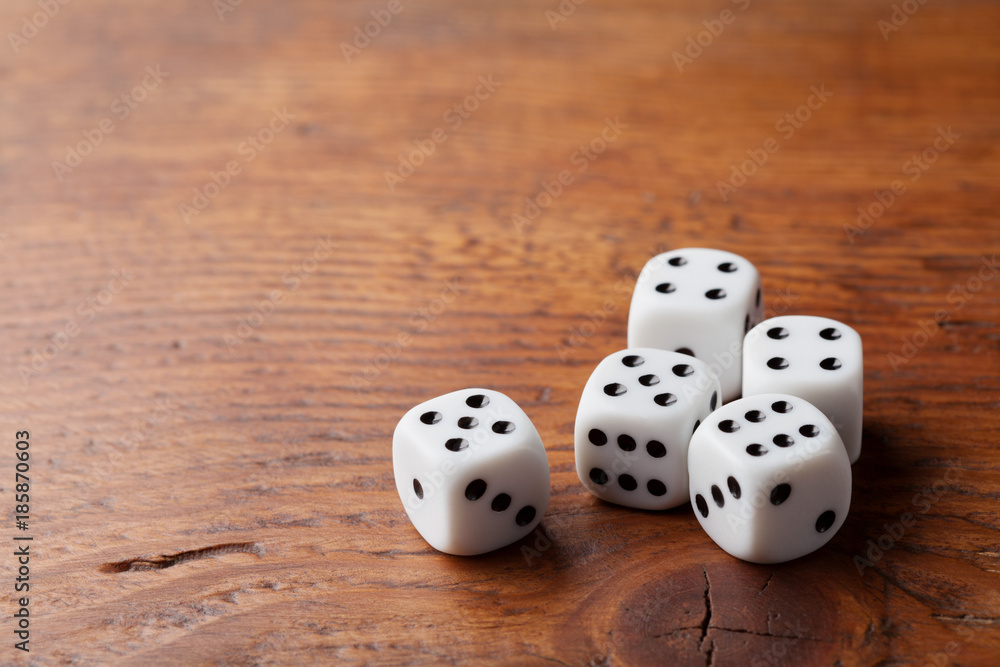 Game of chance concept. Gambling devices. White dice on rustic wooden ...