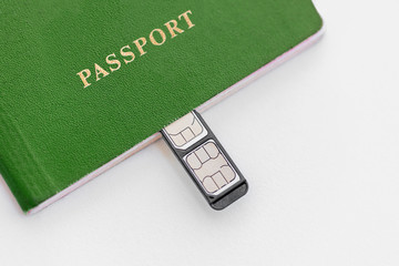 Wall Mural - Green Passport with sim cards on a white background, close-up