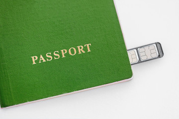 Wall Mural - Green Passport with sim cards on a white background, close-up