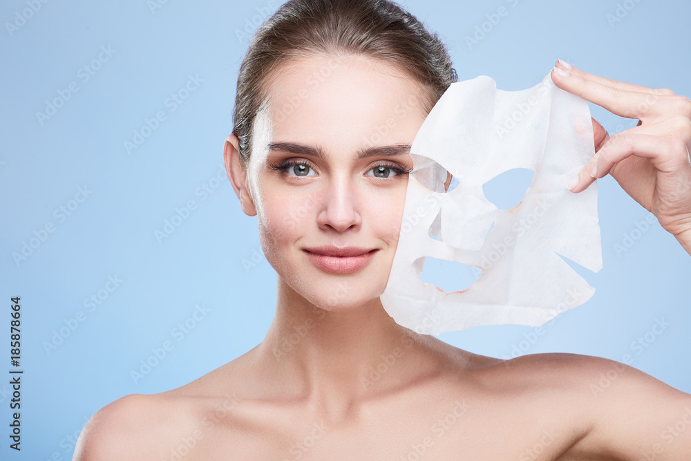 Girl removing mask from face
