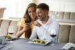 © puhhha - Couple In Love Looking On Phone Having Dinner In Restaurant.