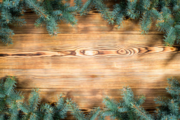 Wall Mural - Christmas wooden background with fir tree. Top view with copy space for your text