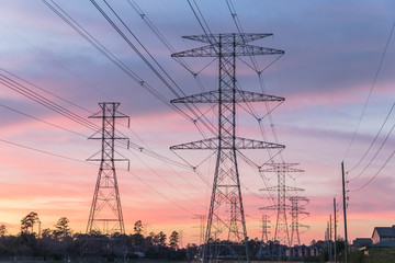 Wall Mural - Industrial background group silhouette of transmission towers (or power tower, electricity pylon, steel lattice tower) at bloody red sunset. Texture of high voltage pillar, overhead power line at dusk