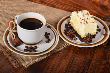 Wall Mural - black coffee in a cup with chocolate cake with free space for text