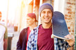 © Sergey Nivens - Teenager boy walking at the street with his skateboard