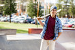 © Sergey Nivens - Teenage boy with skateboard standing outdoors