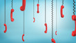 © gearstd - 3d rendering of many red retro phone receivers hang down from black cords on a blue background.
