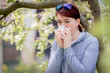 Young woman suffering from Pollen allergy, allergy season, Girl blowing her nose