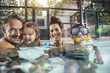 © Westend61 - Portrait of happy family with two children in indoor swimming pool