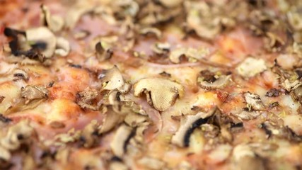 Wall Mural - Fresh made Mushroom Pizza rotating on a plate in detailed 4K (close-up footage; seamless loopable)