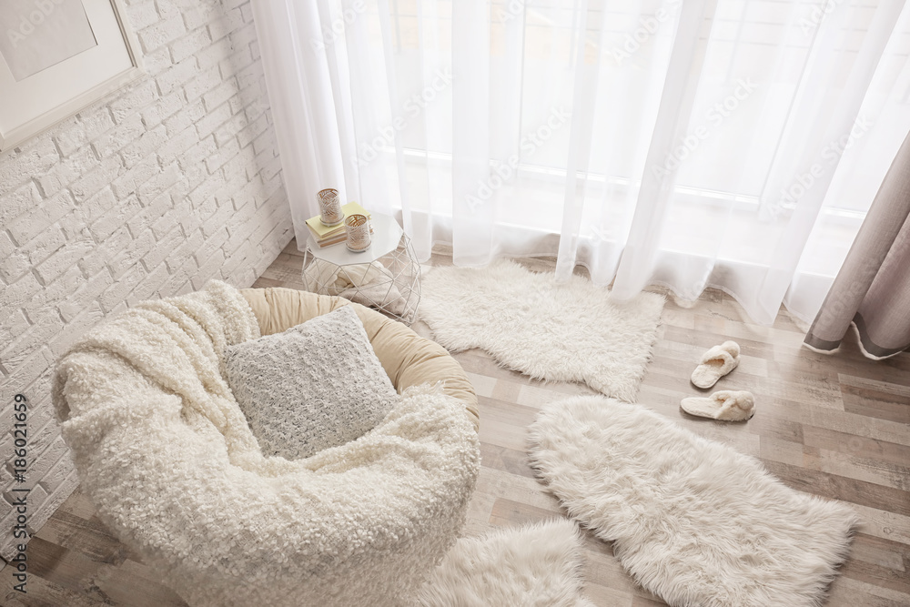 Modern room interior with lounge chair and soft fluffy carpets