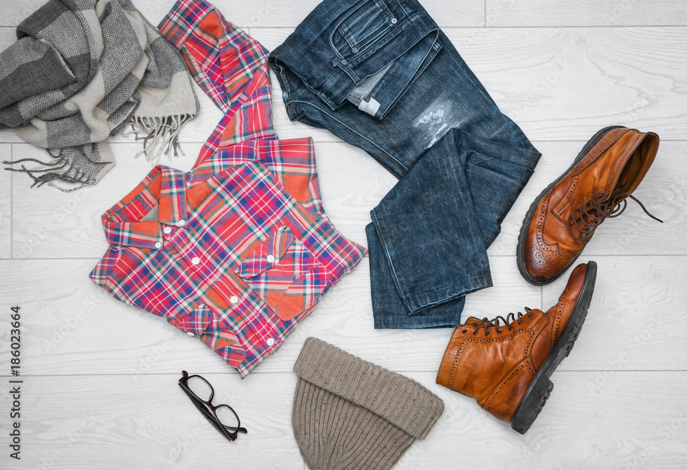 Set of hipster clothes on light background, top view