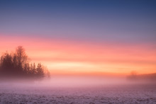 Foggy And Colorful Sunset With Peaceful Landscape At Winter Evening In Finland