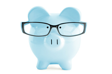 Blue piggy bank in in glasses  isolated on white