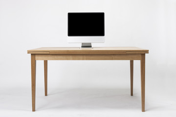computer on the wood desk isolated on the white background.