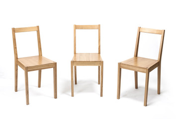 three solid wood chairs isolated the white background.