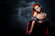 © AS Photo Family - Fashion model red haired girl with originally make up like leopard predator against steel wall. Studio portrait on ladder.