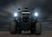 A Man Riding ATV In Sand In Protective  Helmet. Against Dark Cloudy Sky. Blur Effect.