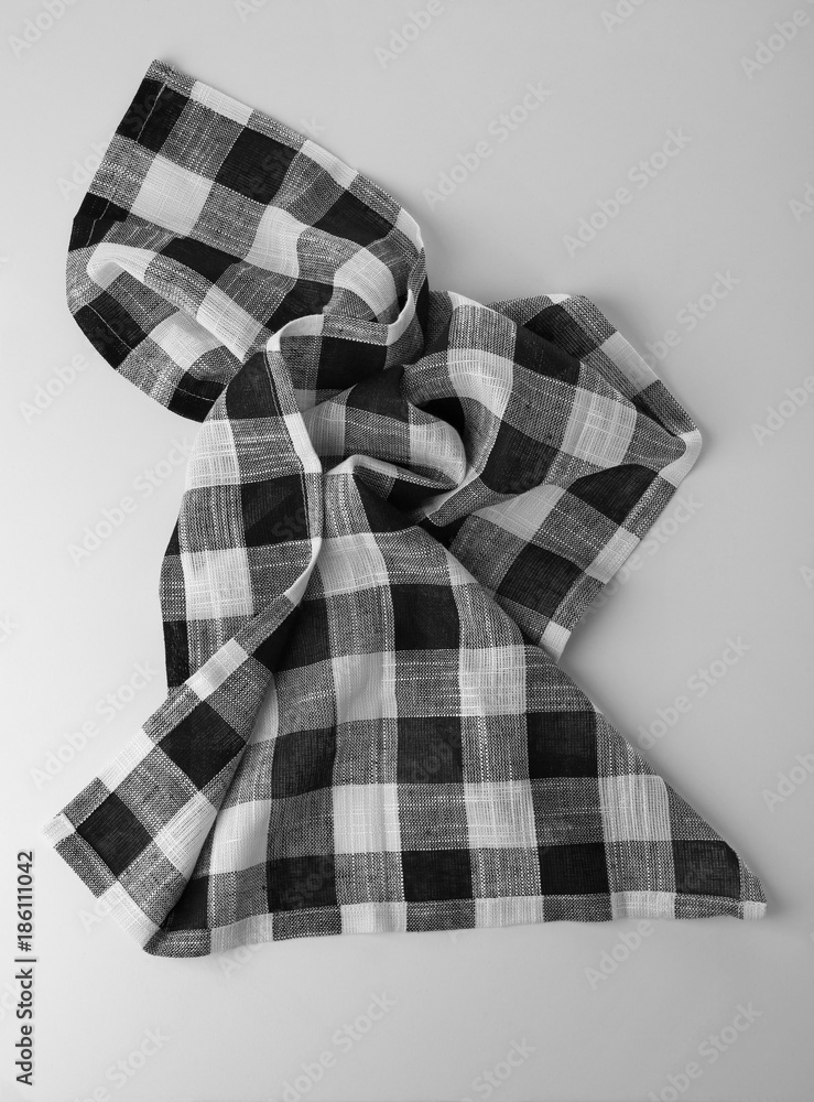 Checkered kitchen towel on light background