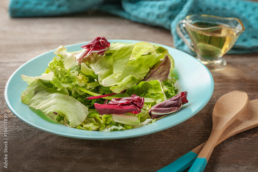 Plate of fresh salad on table