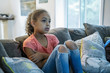 © Inti St. Clair - Kids watching TV at home on couch
