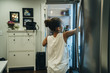 © Inti St. Clair - Girl getting food out of fridge