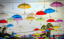  Multicoloured Umbrellas And Cloudy Blue Sky