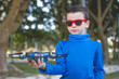 © Michael - Child playing with drone outdoors at summer day