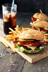 Homemade burger and cheese with fries and icy soft drink