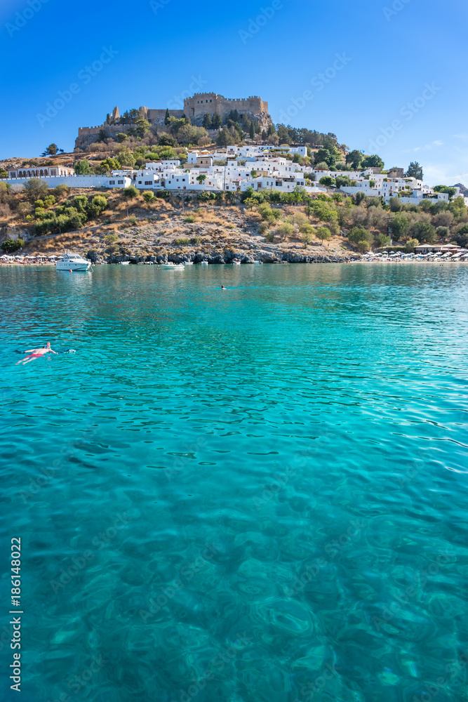 Bay of Lindos and acropolis of Lindos in background (Rhodes, Greece) - obrazy, fototapety, plakaty 