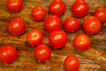 red cherry tomatoes on a rustic wooden table