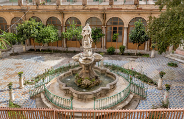 Wall Mural - The majolica cloister with fountain in courtyard of the Santa Caterina church, Palermo, Italy.