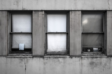 3 glass windows in the abandoned building black and white