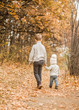 © Ermolaev Alexandr - the elder brother walks with his younger sister in the autumn park