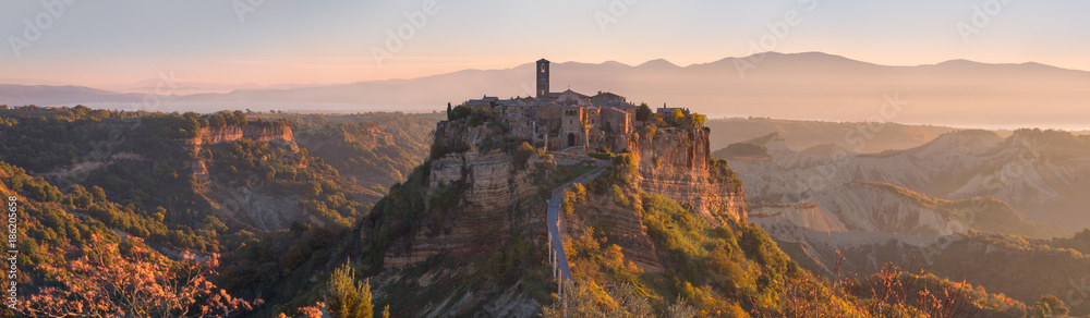 Beautiful panoramic view of famous Civita di Bagnoregio with Tiber river valley at sunset, Lazio, Italy - obrazy, fototapety, plakaty 