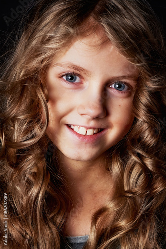 Kinky Girl With Long Hair In The Studio On A Black Background A