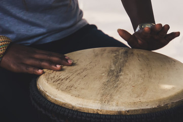 Wall Mural - Close up of hands of a woman playing a drum