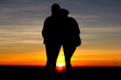 Silhouette love couple on sunset background.