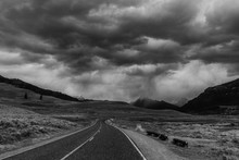 Epic Stormy Sky, Dark Clouds Along Highway Road Trip To Scenic Mountain Landscapes