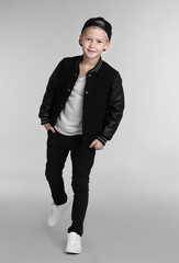 Wall Mural - Cute fashionable boy on light background